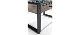 Side view of the Brunswick Striker Foosball Table during easy assembly, featuring modern design details that perfectly complement upscale, contemporary game rooms.