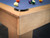 Close-up view of the Paula Parsons pool table’s parsons-style corner joinery, featuring natural maple wood grain and precision-built craftsmanship by Doc & Holliday.