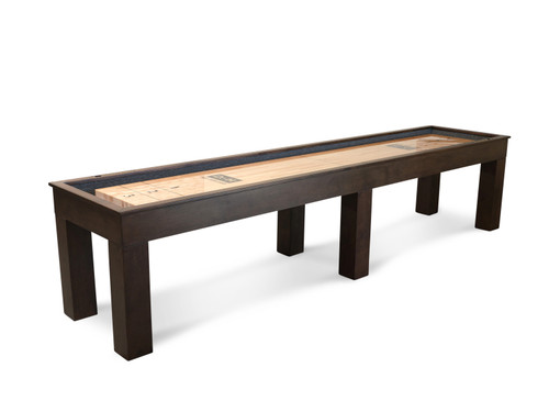 Full side view of the Doc & Holliday Paula Parsons Shuffleboard Table in Antique Coffee, highlighting its modern Parsons silhouette and 12-foot maple playfield set in a luxury industrial-style game room.