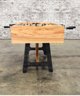 A top-down perspective of the Astoria Industrial Modern Foosball Table, highlighting its regulation-style playfield, seamless ball drop system, and ramped corners for uninterrupted fast-paced action.