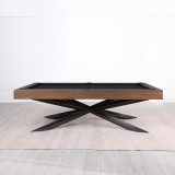 Side angle of the Stella table placed in a modern game room, highlighting the minimalist frame, hardwood build, and eye-catching leg silhouette.

