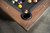 Close-up view of the luxurious genuine leather drop pockets on the Nixon Billiards Kai Slate Pool Table, adding sophistication and quiet gameplay.