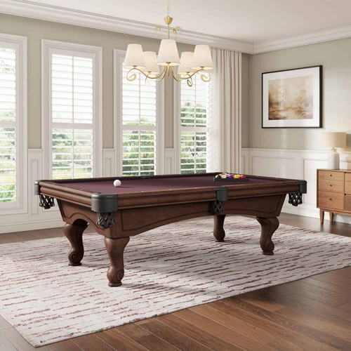 The Maddie Pool Table is styled in a modern rustic game room setting, featuring its Sierra finish and warm woodgrain tone. The angled view provides a sense of space, showing how the table becomes a statement piece in both classic and contemporary interiors.