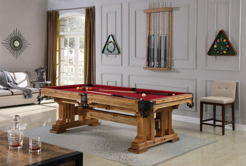 The Playcraft Colorado Slate Pool Table in Saddle finish styled in a rustic-chic game room with reclaimed wood walls, soft ambient lighting, and vintage bar seating. This image showcases the table’s timber frame silhouette and trestle base, highlighting why it’s a favorite among Sawyer Twain’s rustic slate pool table collection.