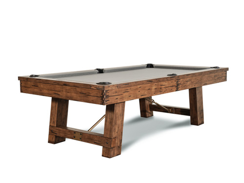 A clean, high-quality shot of the Isaac Slate Pool Table in Distressed Brulee Brown & Gold finish, displayed against a white background to showcase its luxurious craftsmanship. The oversized gold turnbuckles, genuine leather drop pockets, and distinctive 1” 3-piece slate are highlighted, emphasizing the table’s industrial design and rustic appeal.