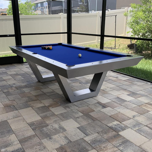 Installed under a covered outdoor kitchen and dining space, the Matrix Pool Table serves as a design-forward game station with its modern frame and moisture-resistant Sunbrella felt.