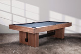The Vancouver Slate Pool Table in Honey Ash, styled in a luxury game room with ambient lighting and warm neutral décor. The custom reeded wood legs and matte slate surface make it a conversation-starting centerpiece, perfect for keywords like “modern slate pool table styled in designer home” or “game room furniture with contemporary wood finish.