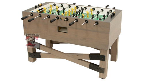 A three-quarter angled view of the Tornado Rustic Foosball Table, photographed on a crisp white background. The table showcases its signature Rustic Farmhouse finish with visible wood grain texture, a solid 1.5" MDF cabinet, and durable down-corner construction. Solid wood handles are mounted on chrome rods with patented Tornado men aligned across a ¾" tournament-grade laminate playfield. This image highlights the table’s bold silhouette, competitive design, and premium American craftsmanship.